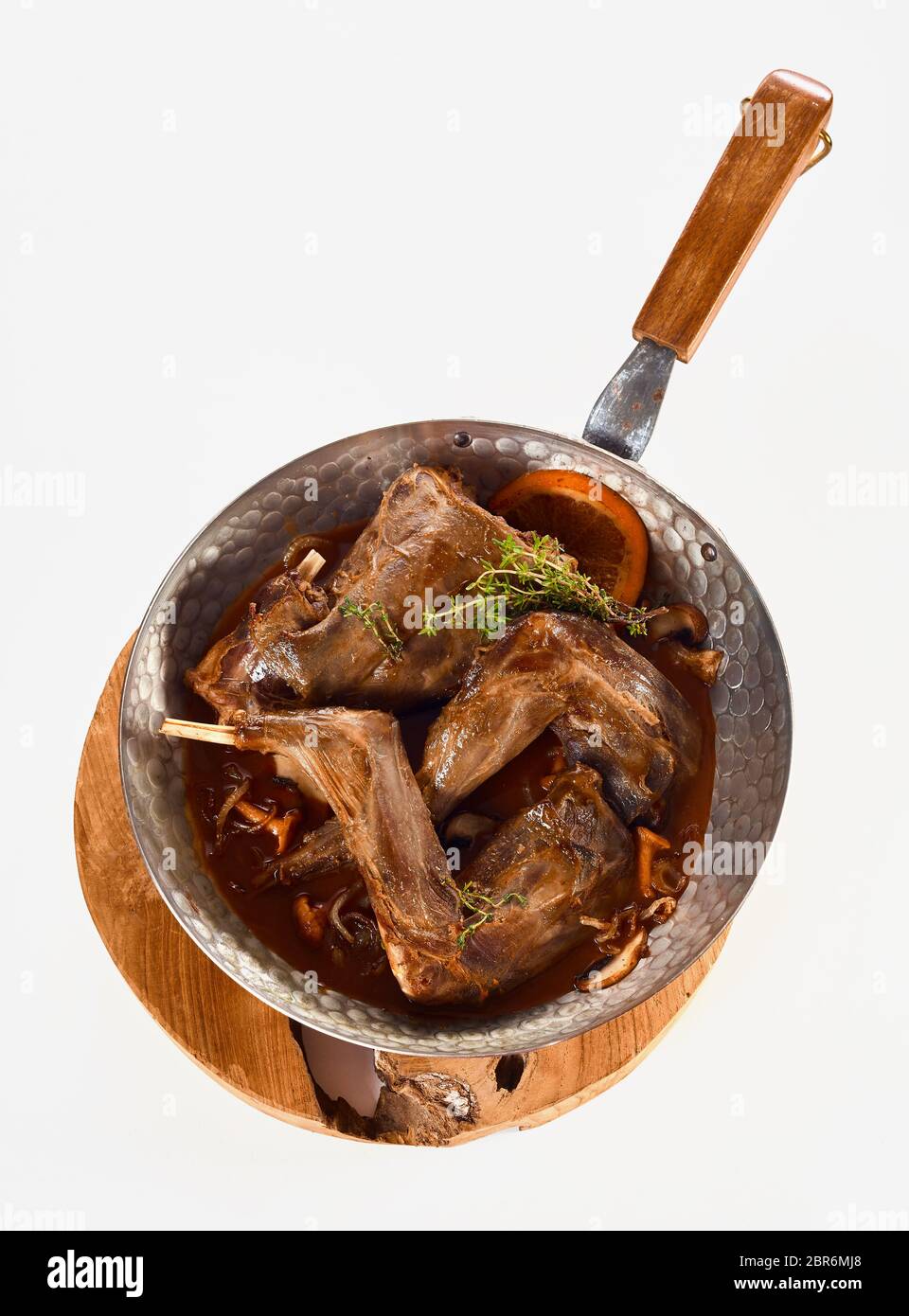 Portions of roasted wild rabbit venison in gravy seasoned with spices ...