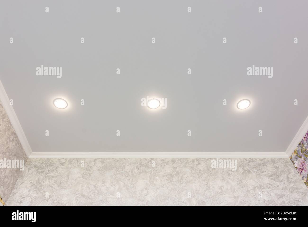 Three spotlights built into the suspended ceiling Stock Photo