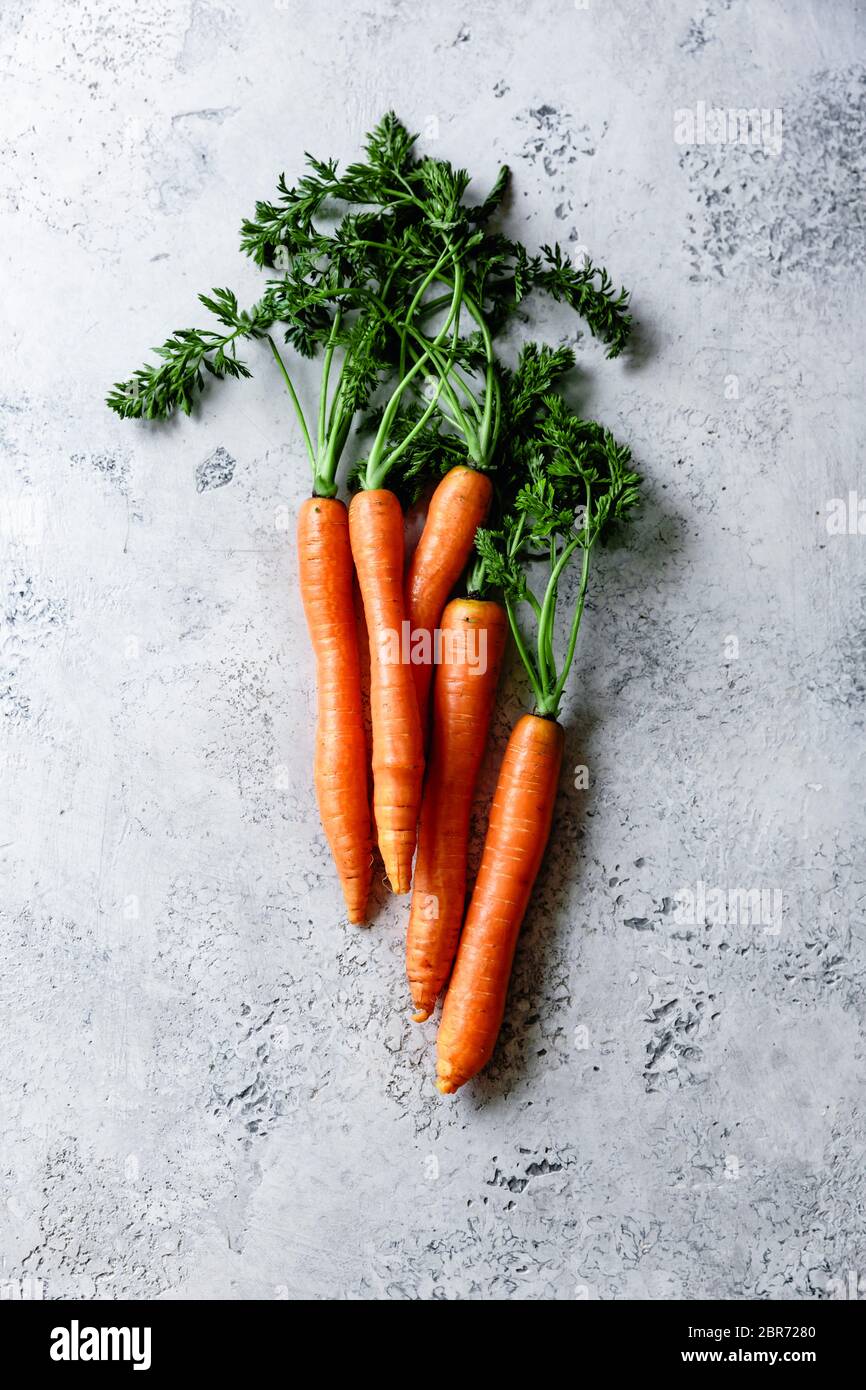 Fresh carrots on a textured blue background. Stock Photo