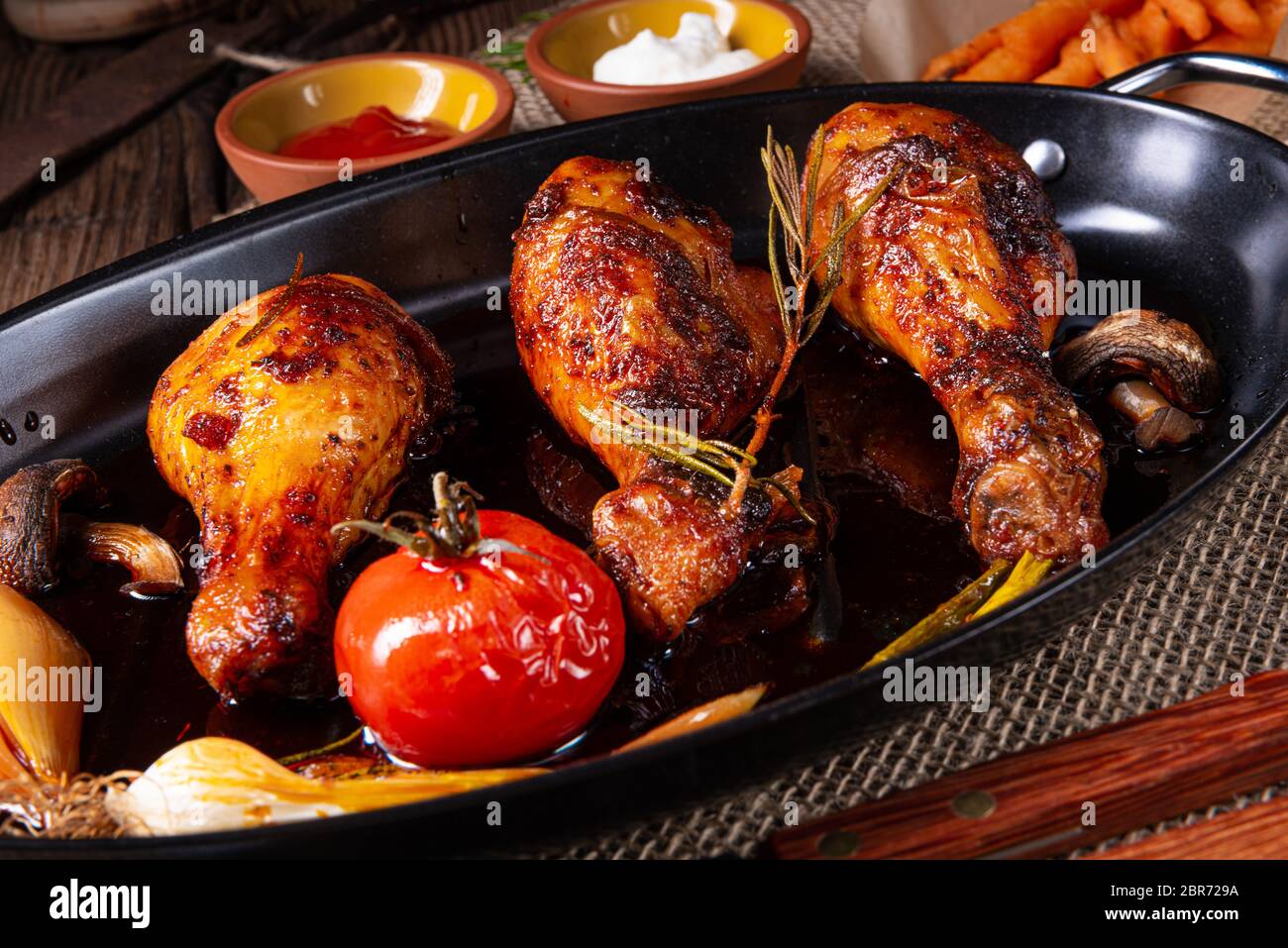 grilled chicken legs in barbecue marinade with sweet potatoes Stock