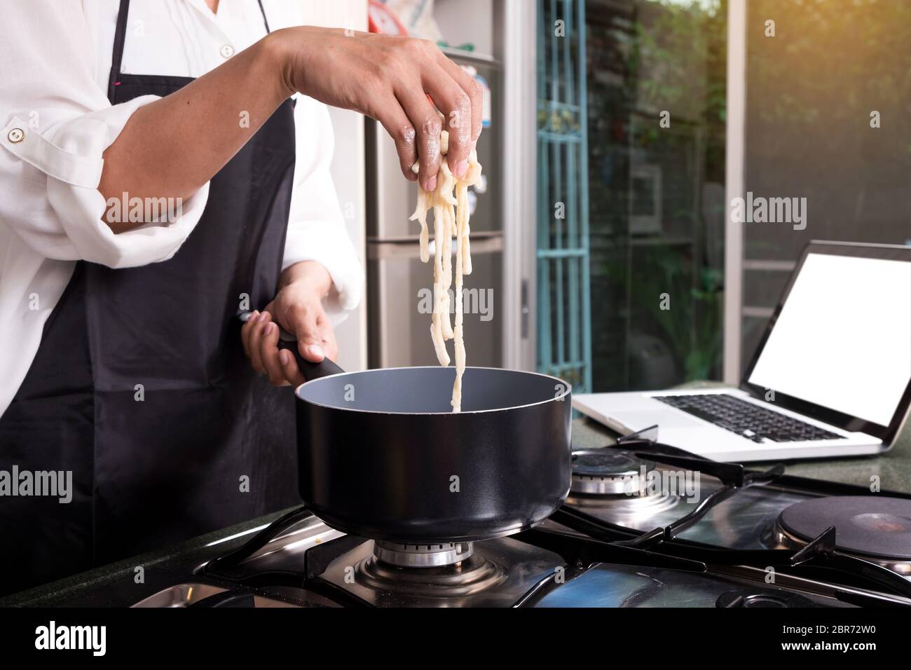 Chef Cutting cook Homemade makes dough fresh Pasta Stock Photo