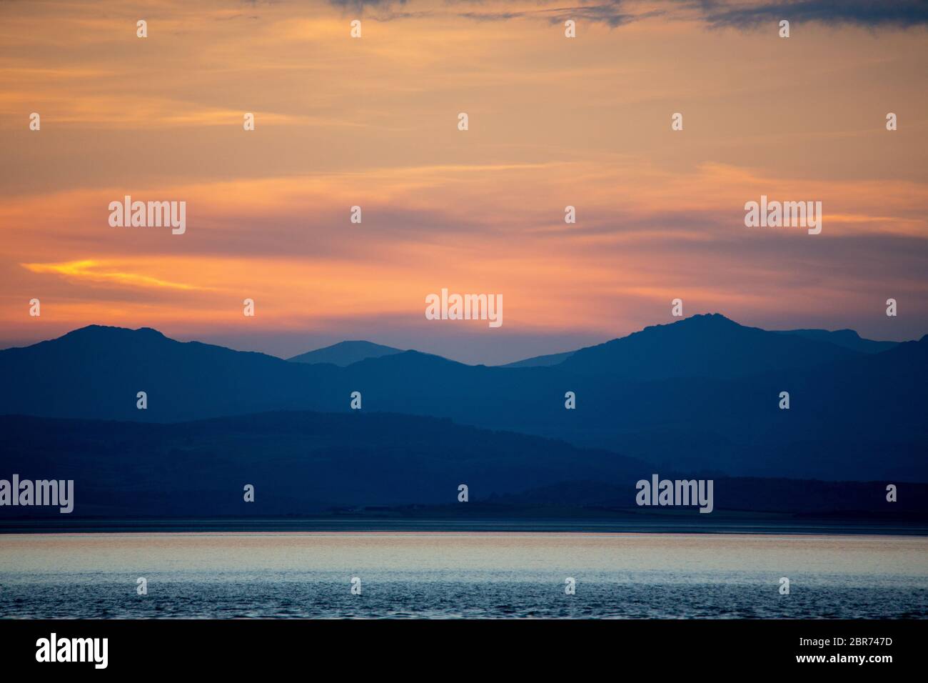 Morecambe, Lancashire, United Kingom 20th May 2020, After the warmest day of the year dusk Morecambe Bay is treated to its own spectacular view at the end of the day Credit: PN News/Alamy Live News Stock Photo