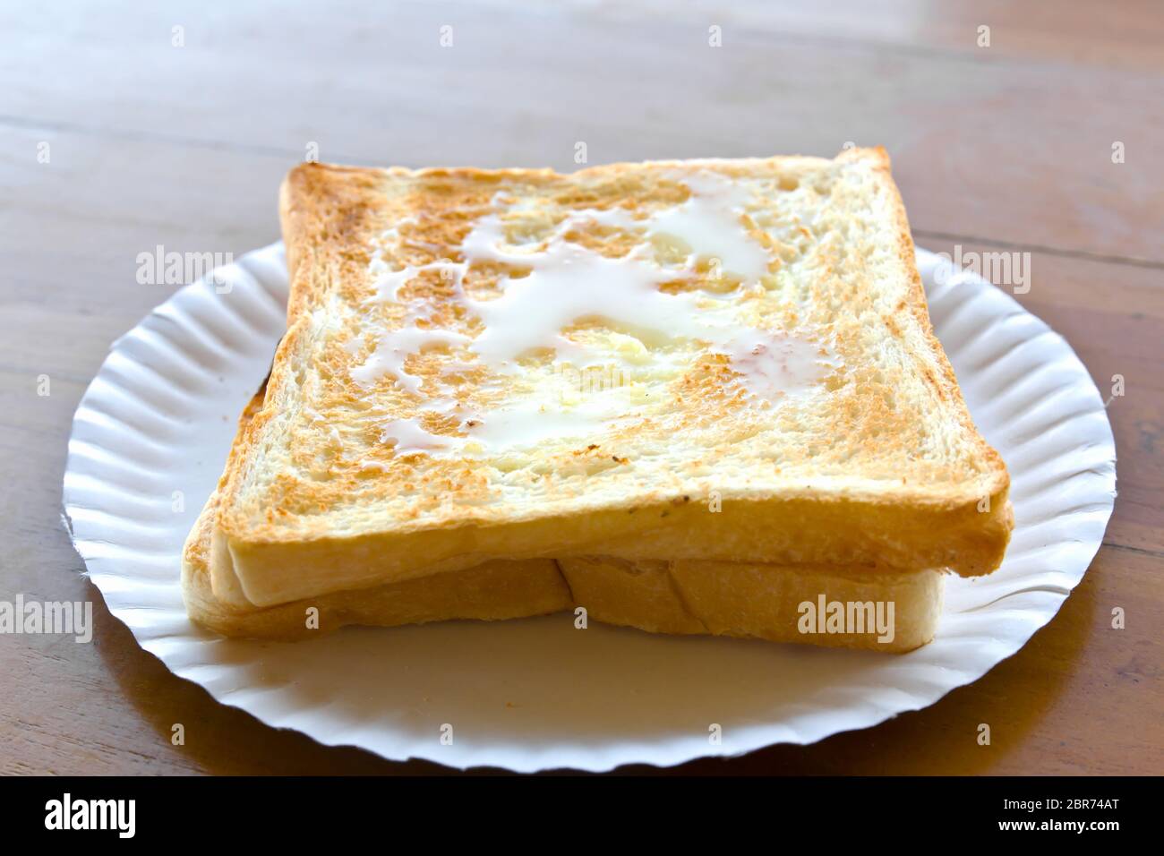 Pour the milk toast in the dish Stock Photo Alamy