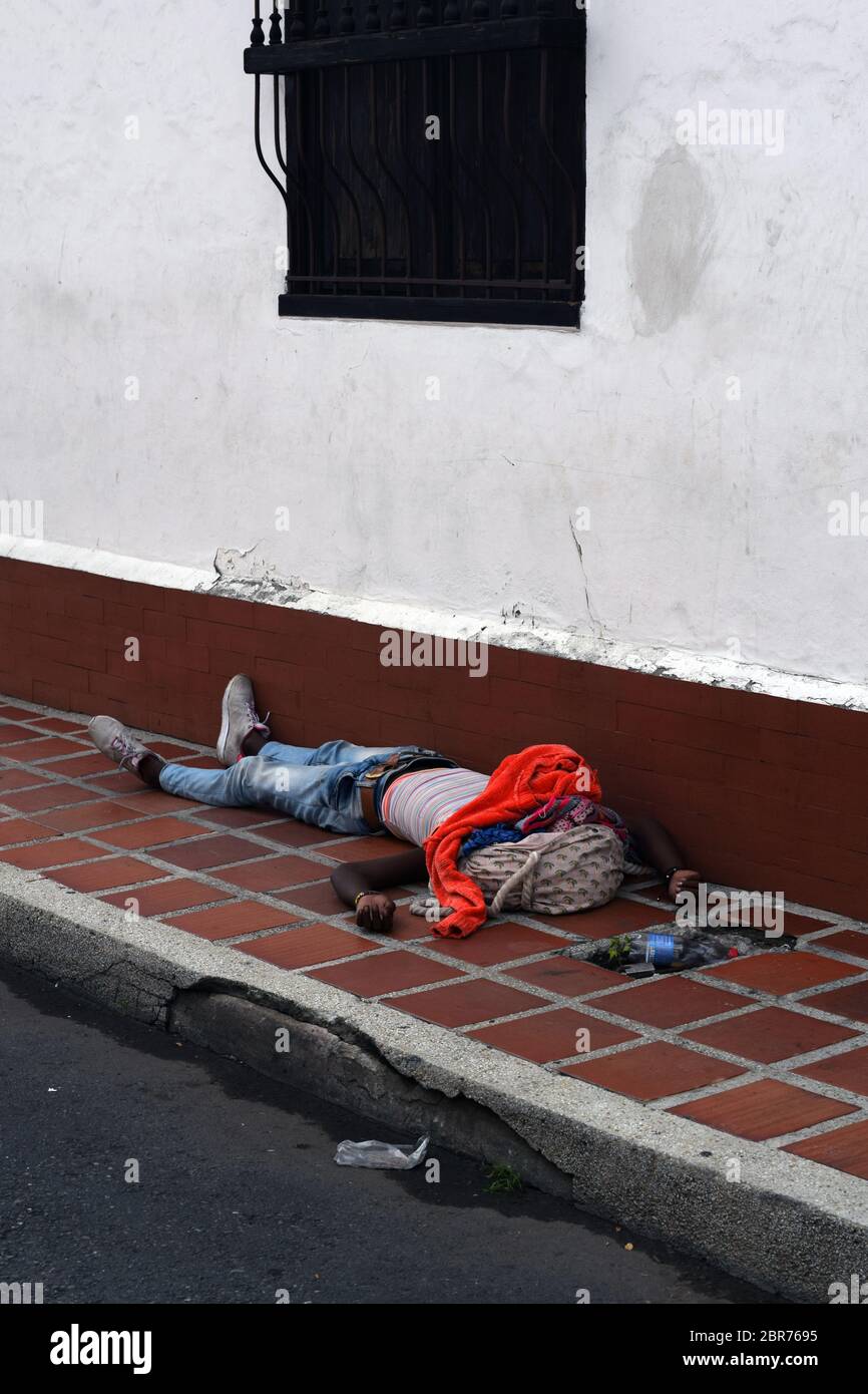 Homeless man sleeping in the streets of Cali during Coronavirus outbreak in Colombia Stock Photo