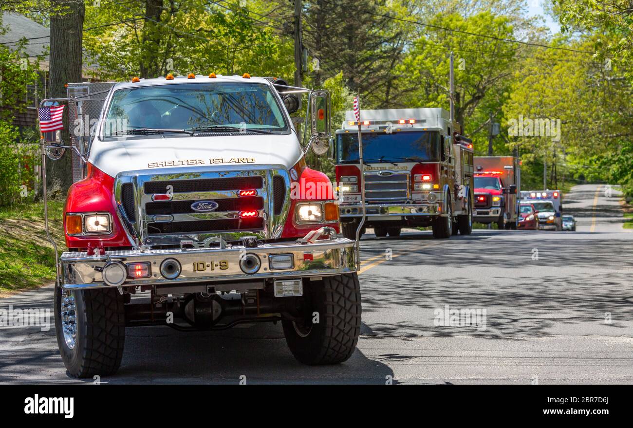 Several Shelter Island emergency vehicles with lights on Stock Photo