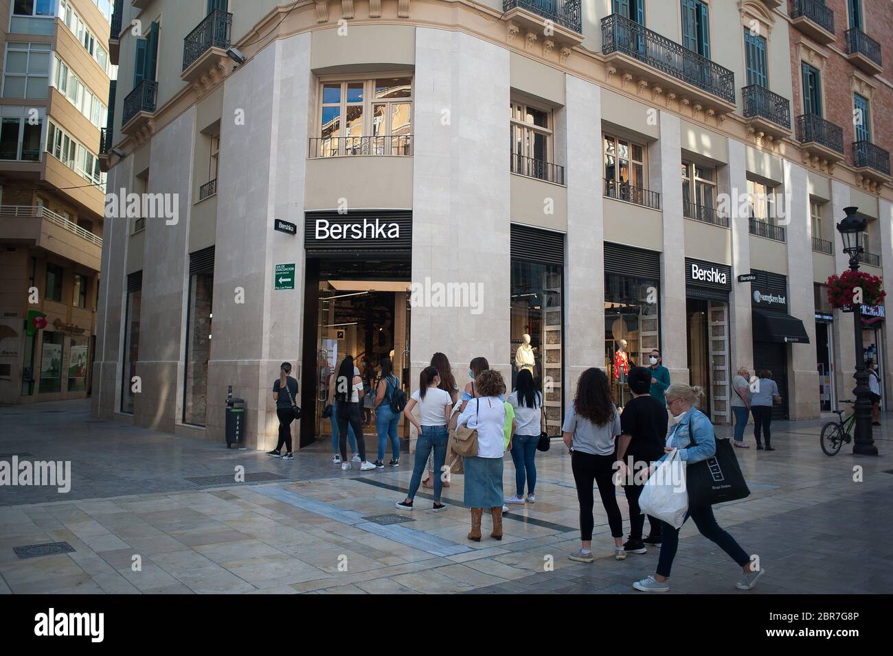 May 20, 2020, Malaga, Spain: People wait in queue outside 'Bershka'  clothing store at Marques de Larios street during a nationwide partial  lockdown.Spain is going through a plan of down-scaling towards a ''