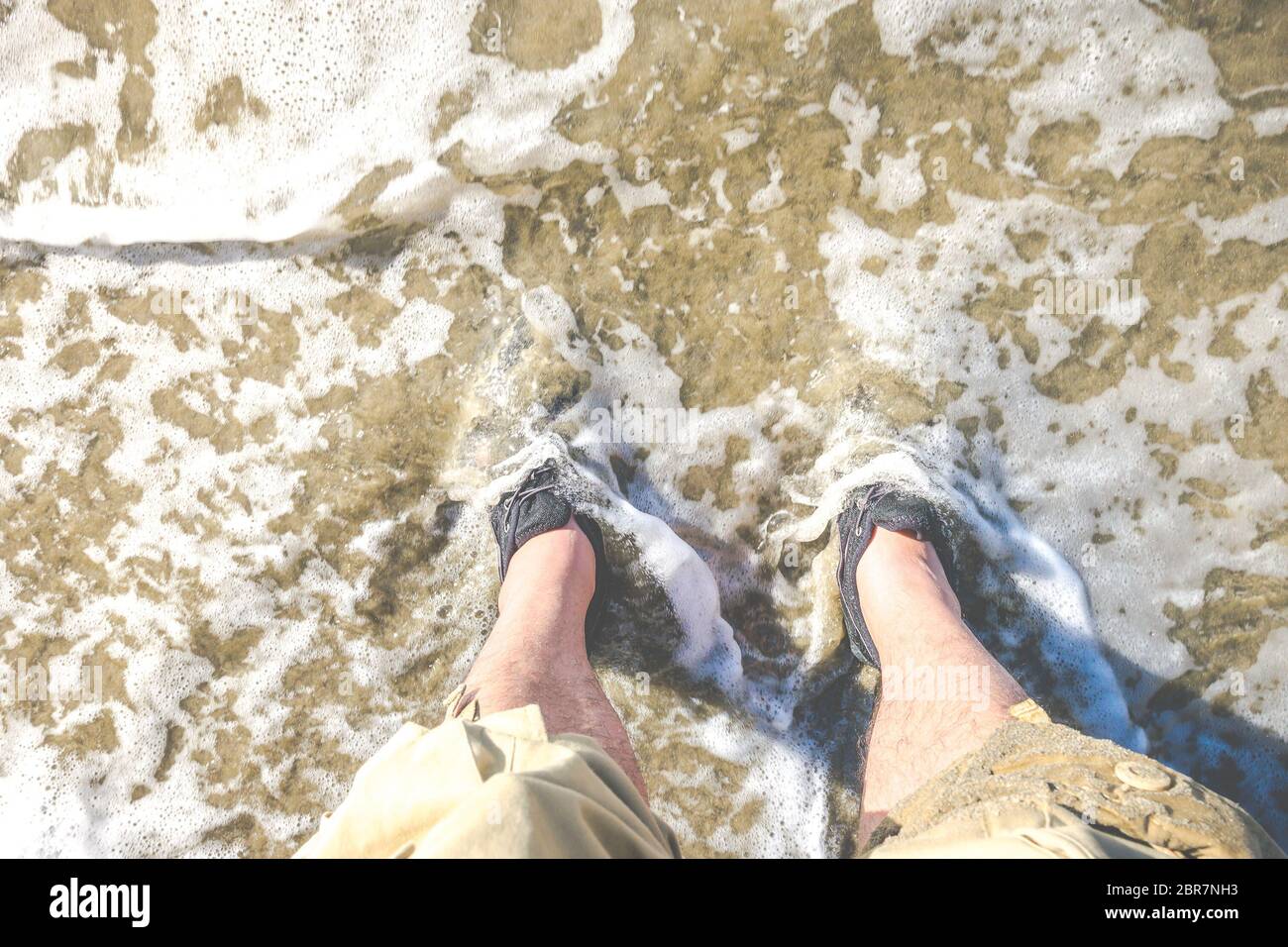 foot with water shoe on the beach Stock Photo Alamy