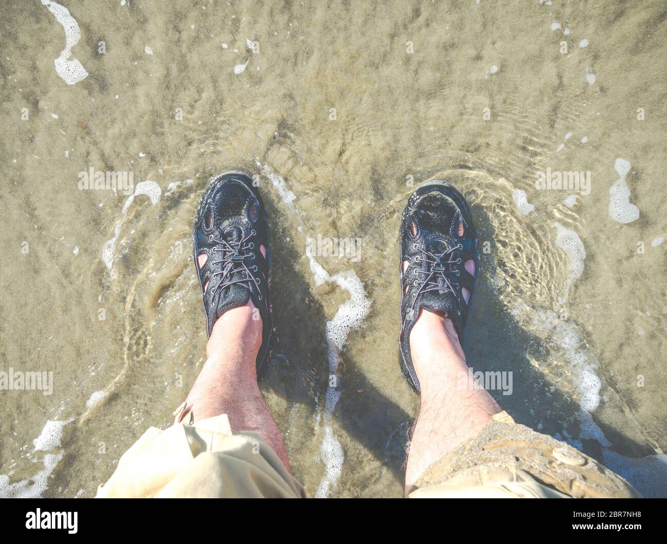 foot with water shoe on the beach Stock Photo Alamy