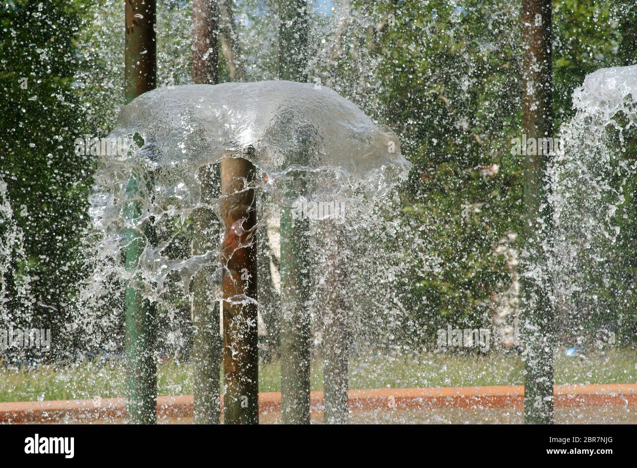 The closeup of rippling water fountains and water drops of a fountain. Stock Photo