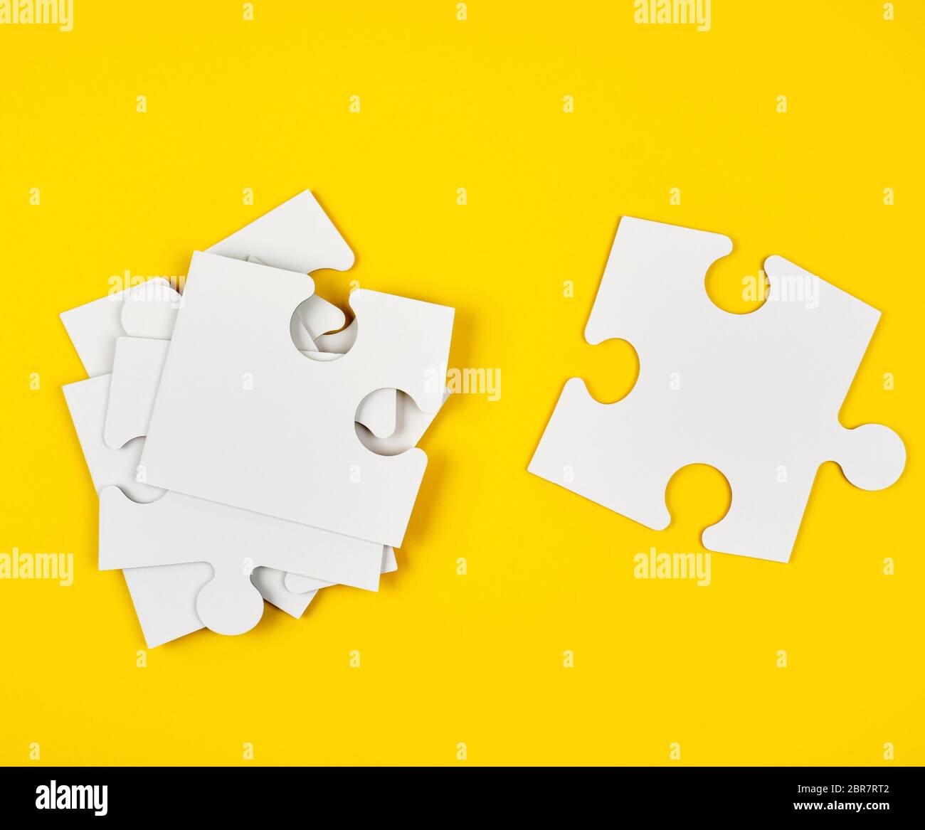 blank white big puzzles on yellow background, flat lay Stock Photo
