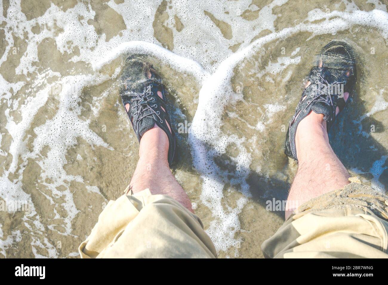 foot with water shoe on the beach Stock Photo Alamy
