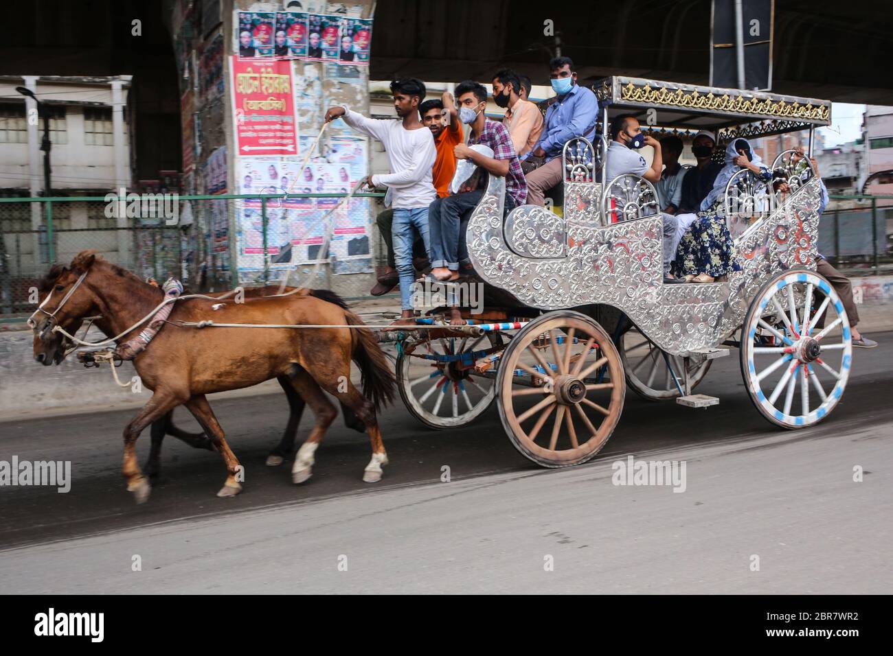 Dhaka, Dhaka, Bangladesh. 20th May, 2020. Horse carriages are one of the mostly used public transport during this covid-19 pandemic, as public transport is on hault to prevent covid-19 from being spread.But while travelling in horse chariot, people were seen to ignore social distancing fully. Credit: Md. Rakibul Hasan/ZUMA Wire/Alamy Live News Stock Photo