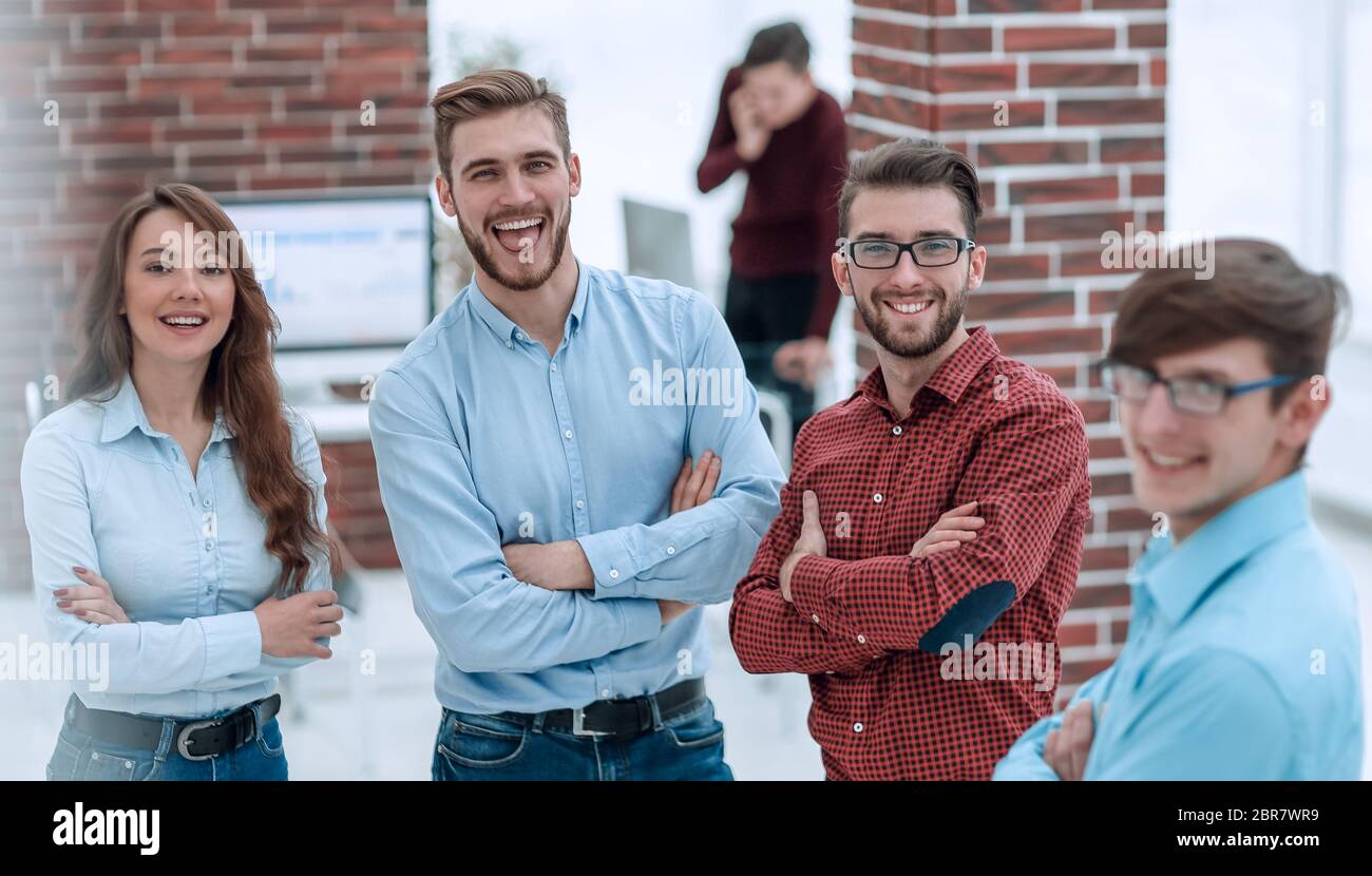 Happy smiling business team in office Stock Photo - Alamy