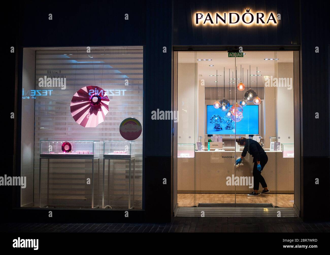 An employee disinfecting inside the jewerly 'Pandora' shop at Marques de  Larios street during a nationwide partial lockdown. Spain is going through  a plan of down-scaling towards a "new normality" by relaxing