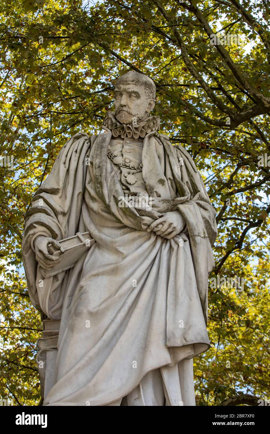 Statue of Michel de Montaigne in public garden along Place des