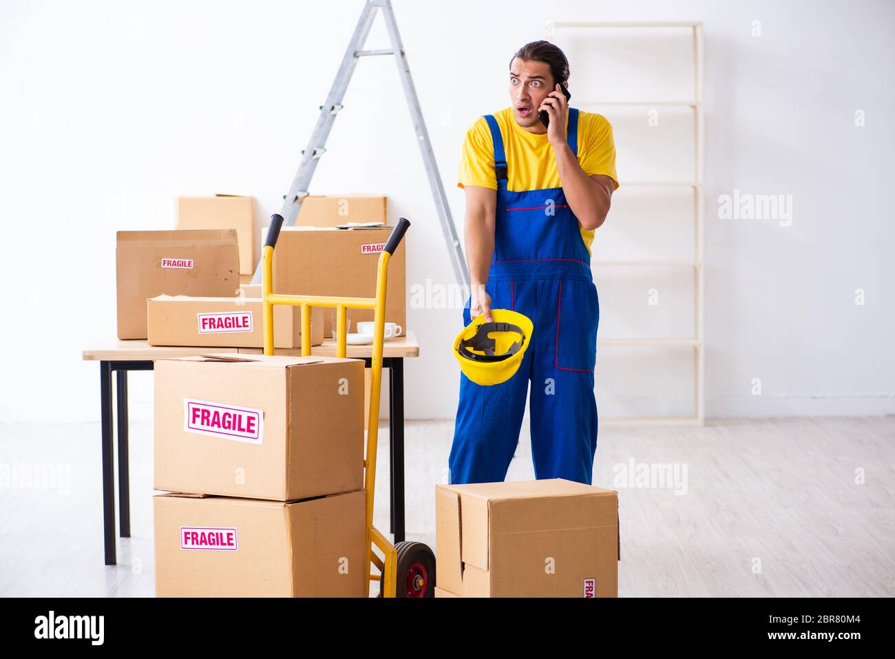 Young professional mover doing home relocation Stock Photo