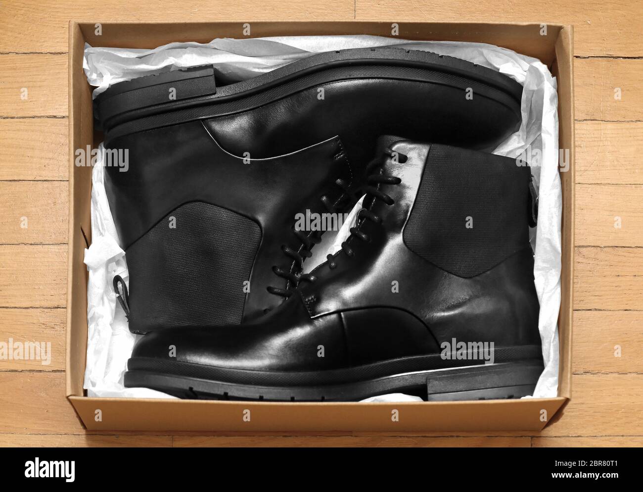 Modern black leather male boots inside cardboard box Stock Photo Alamy