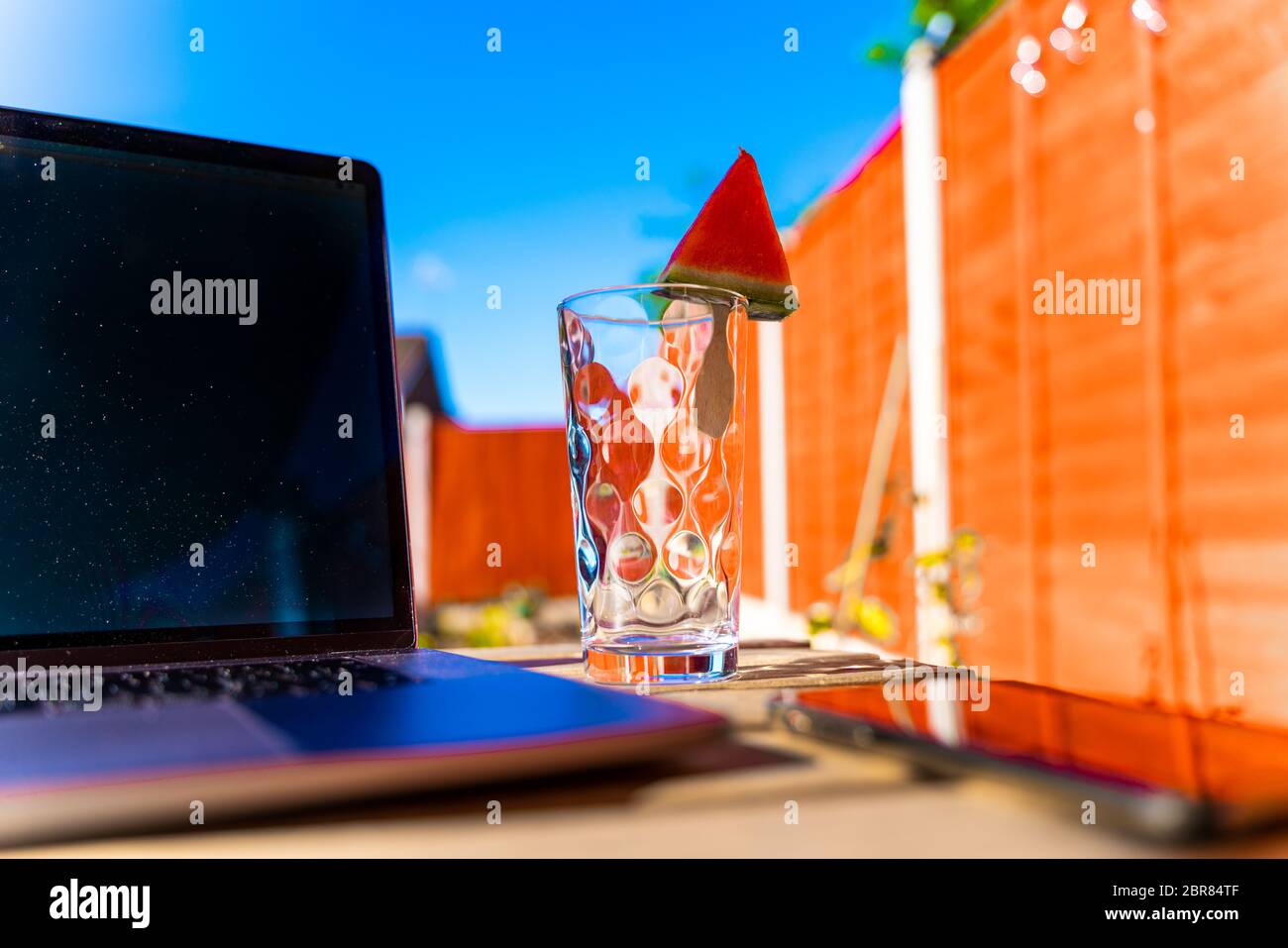 Icy watermelon slice shaped of a triangle on a glass. Iced fruits are a good option while relaxing at the backyard especially on bank holidays Stock Photo