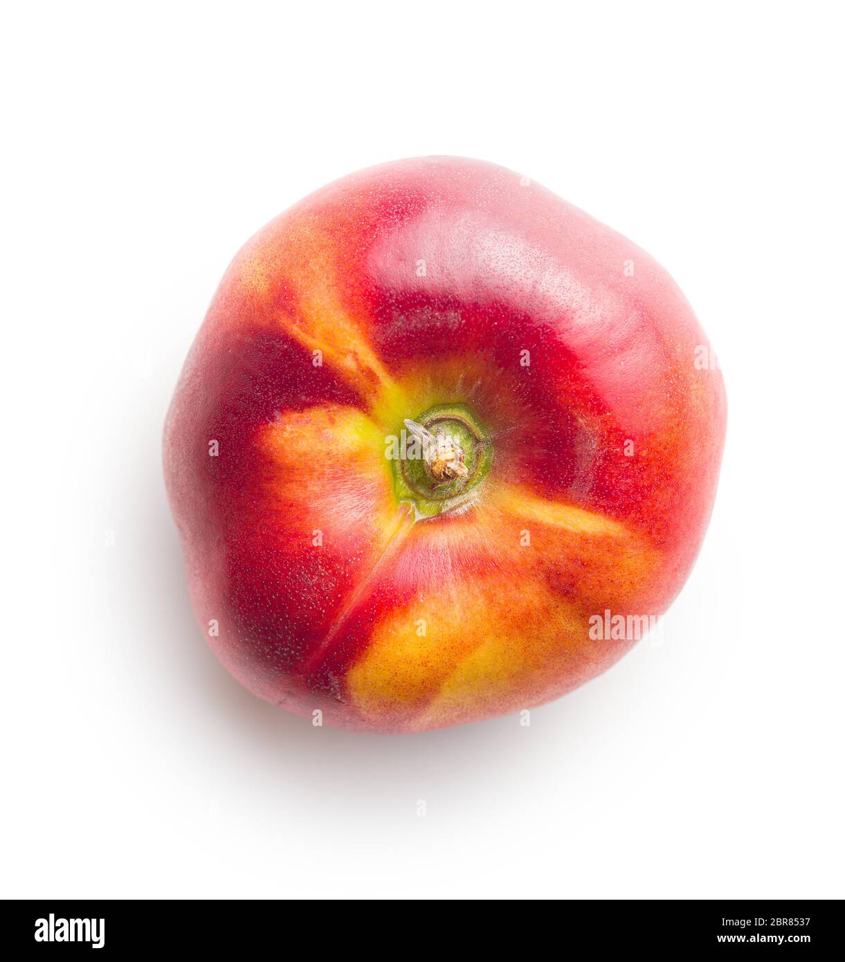 Ripe flat nectarine isolated on white background. Stock Photo