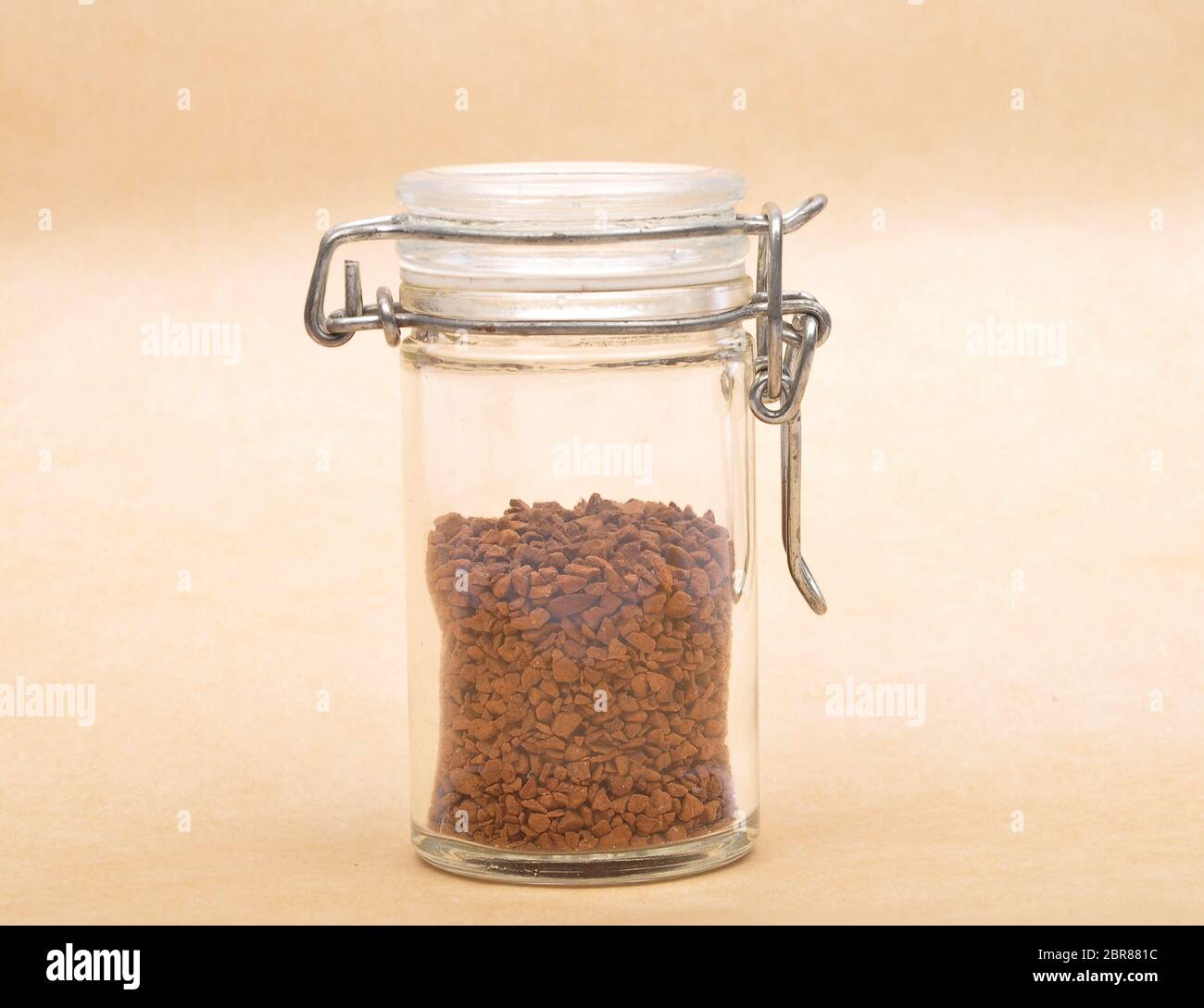 Instant Coffee in closed jar on brown background Stock Photo