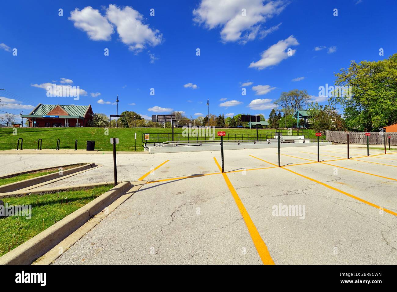 Winfield, Illinois, USA. An empty commuter railroad station parking lot is completely empty despite being a rush hour afternoon. Stock Photo