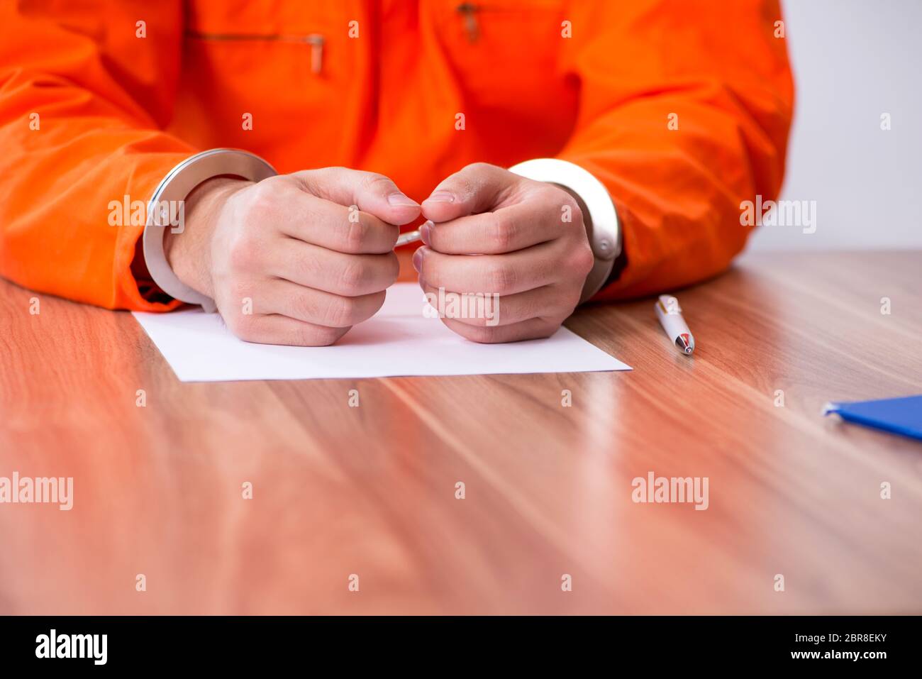 Young man writing letter in the provisional detention Stock Photo
