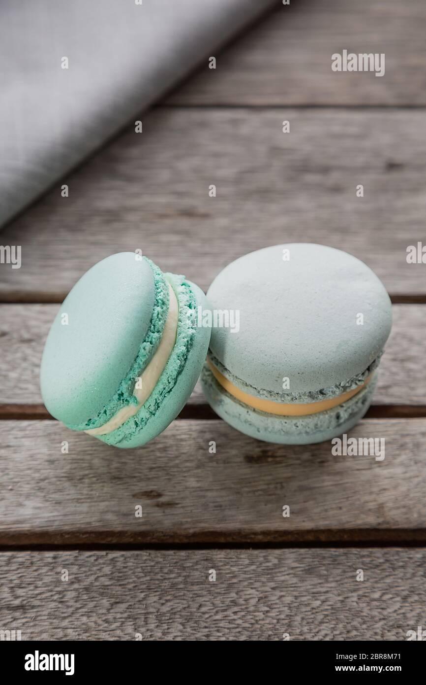 Homemade Fresh Colorful French macarons cake, on natural concrete wooden background. Food concept with copy space. Vertical image. Stock Photo