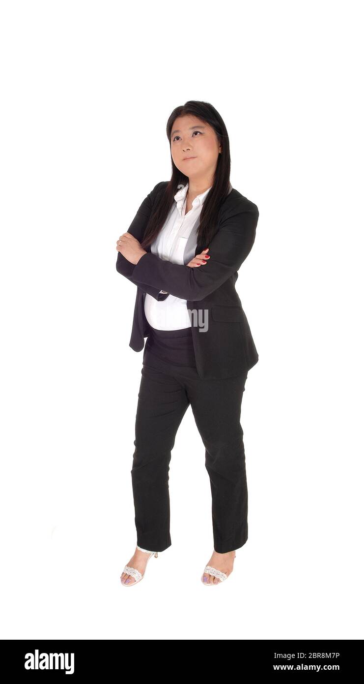 A lovely smiling Asian business woman standing with her arms crossed in ...