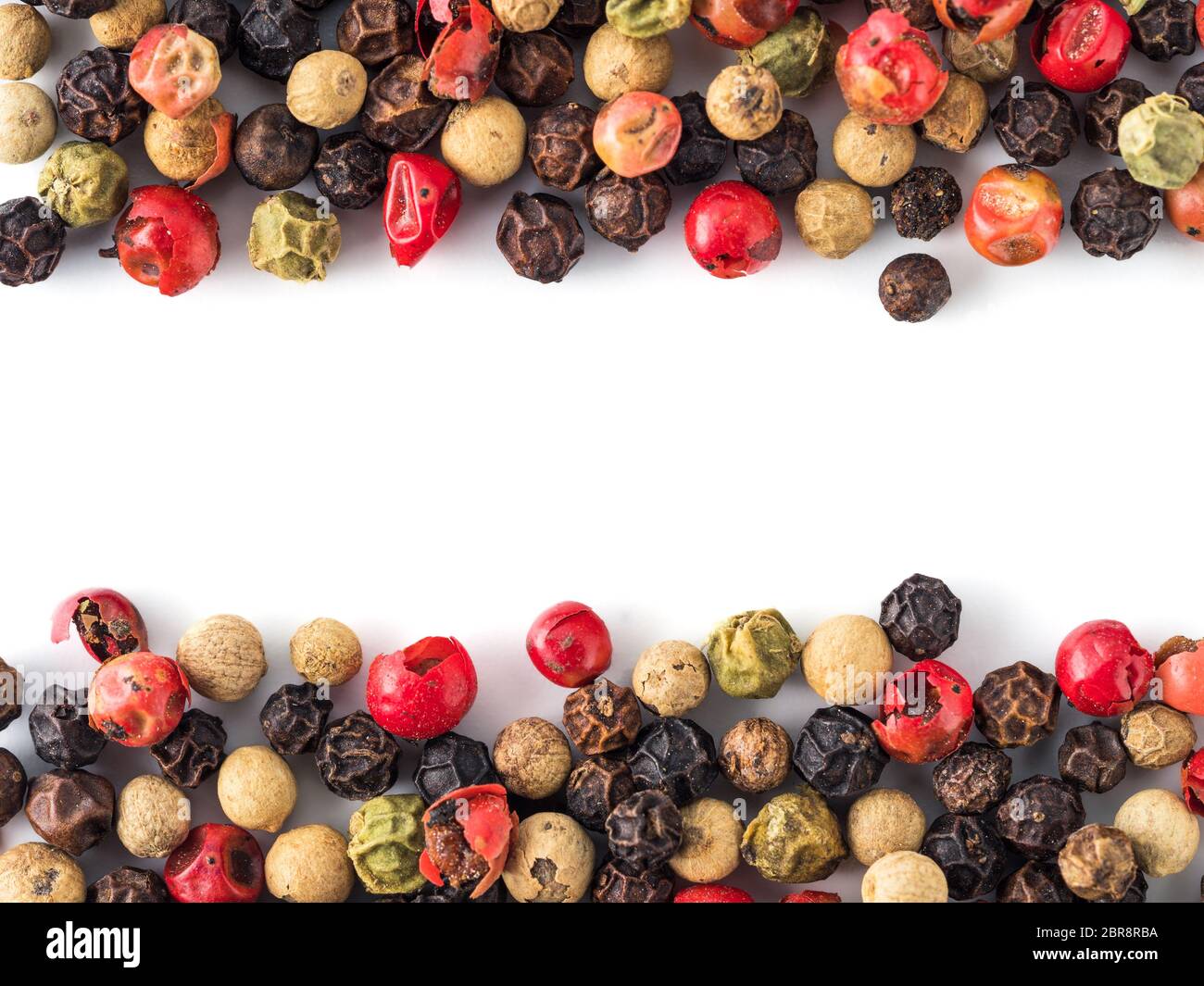Mixed peppercorns background with white copy space in center. Food