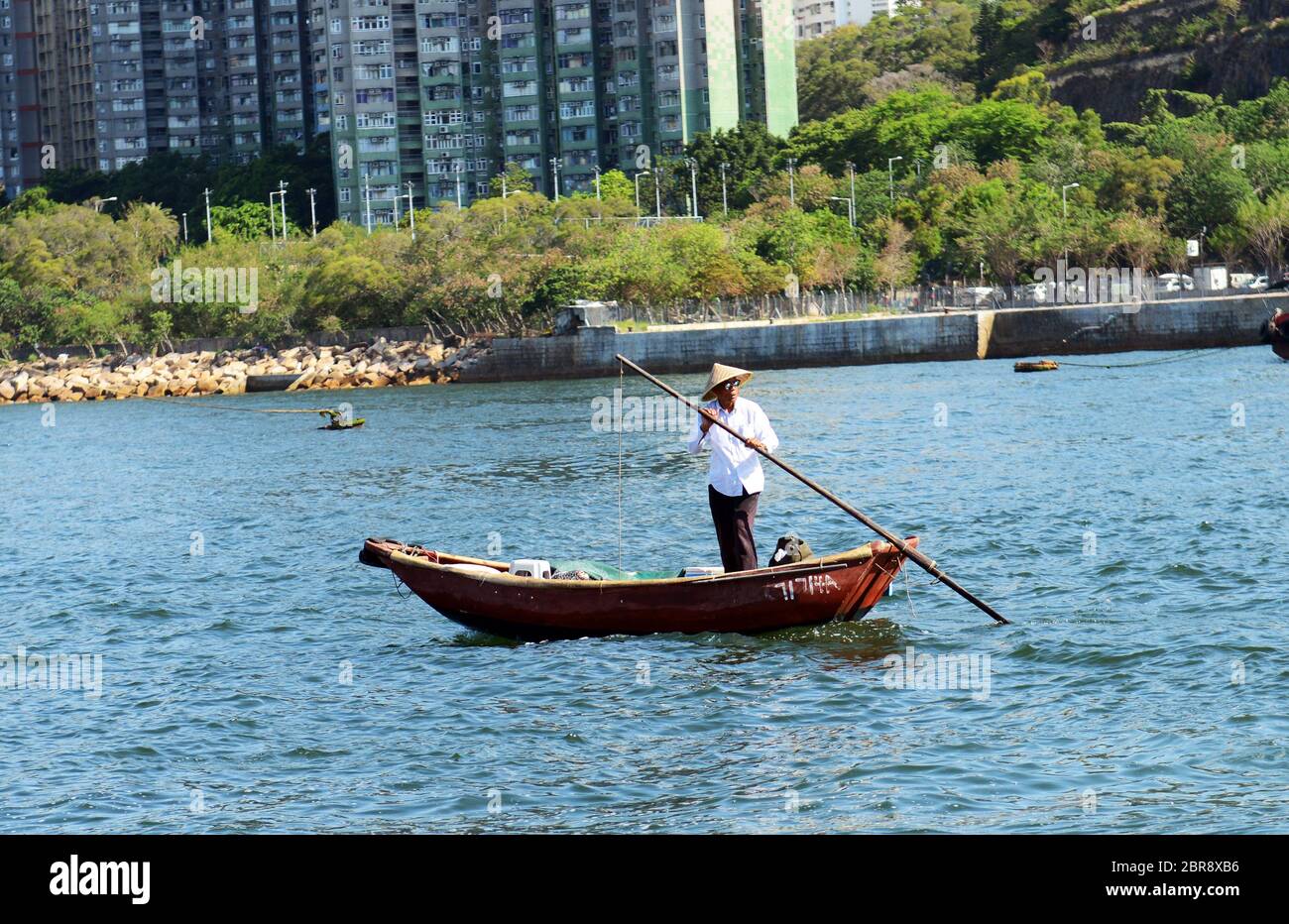 A fisherman fishing in the Aberdeen harbour in Hong Kong. Stock Photo