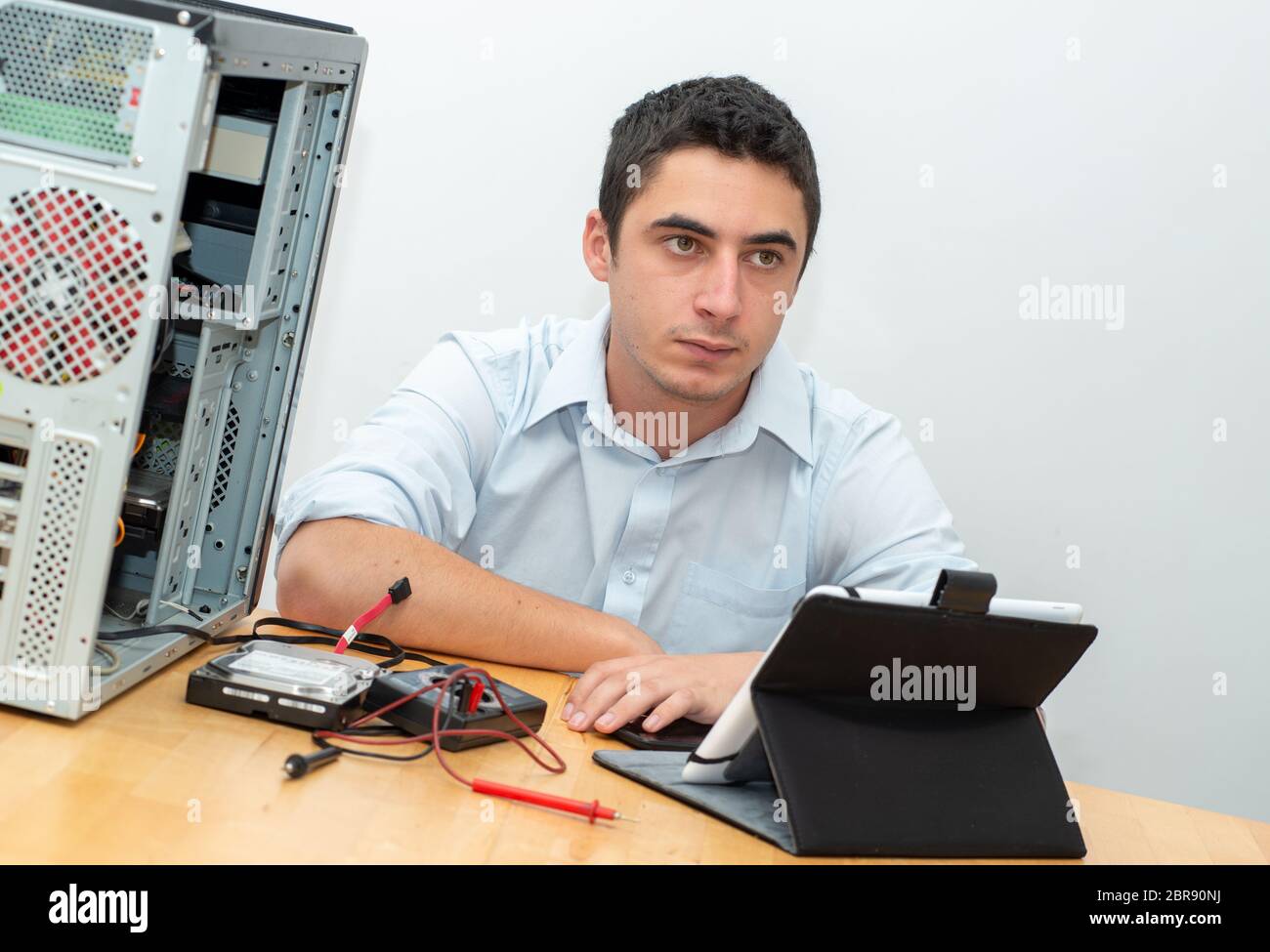 a young man technician repair computer Stock Photo - Alamy