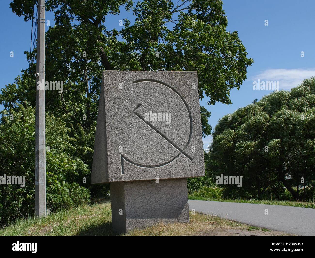 granite monument with a sickle and hammer, a communist symbol of the Soviet Union Stock Photo