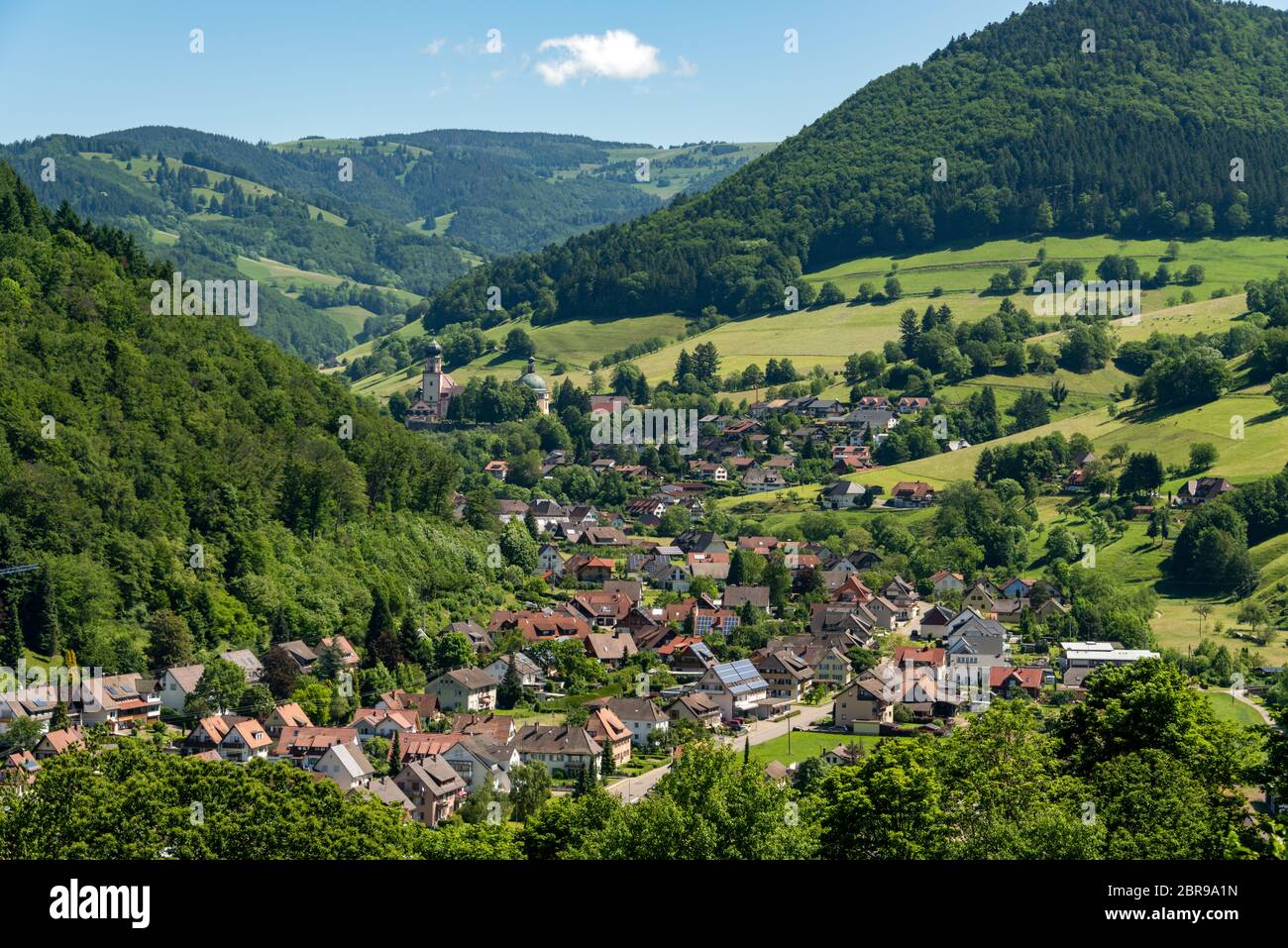 Wonderful landscape image of the small climatic resort village Muenstertal in the black forest with hills, meadows and mountain in the background Stock Photo