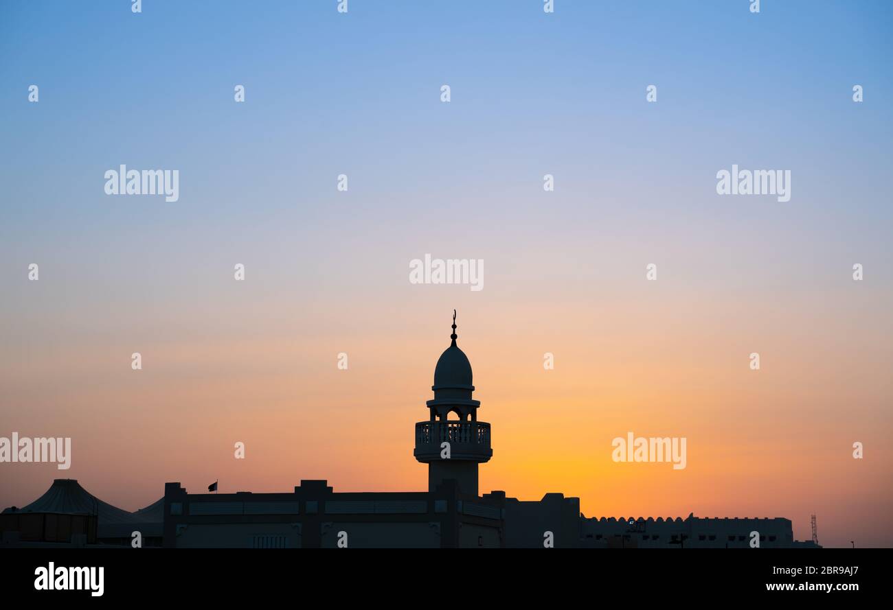 background image of mosque minaret during sunset sunset Stock Photo