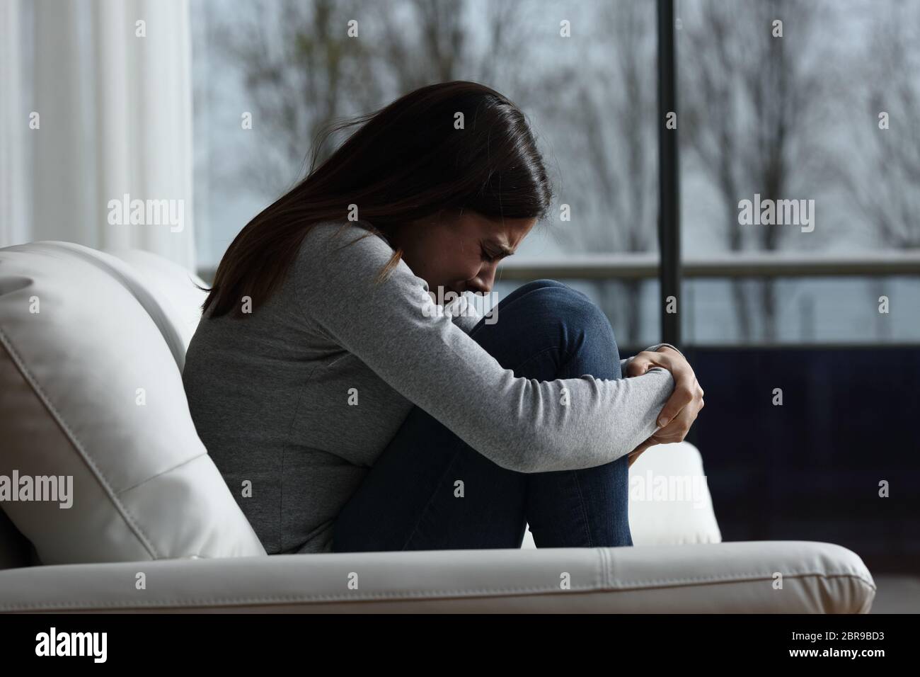 sad woman crying, looking aside on black background, closeup portrait,  profile view Stock Photo - Alamy