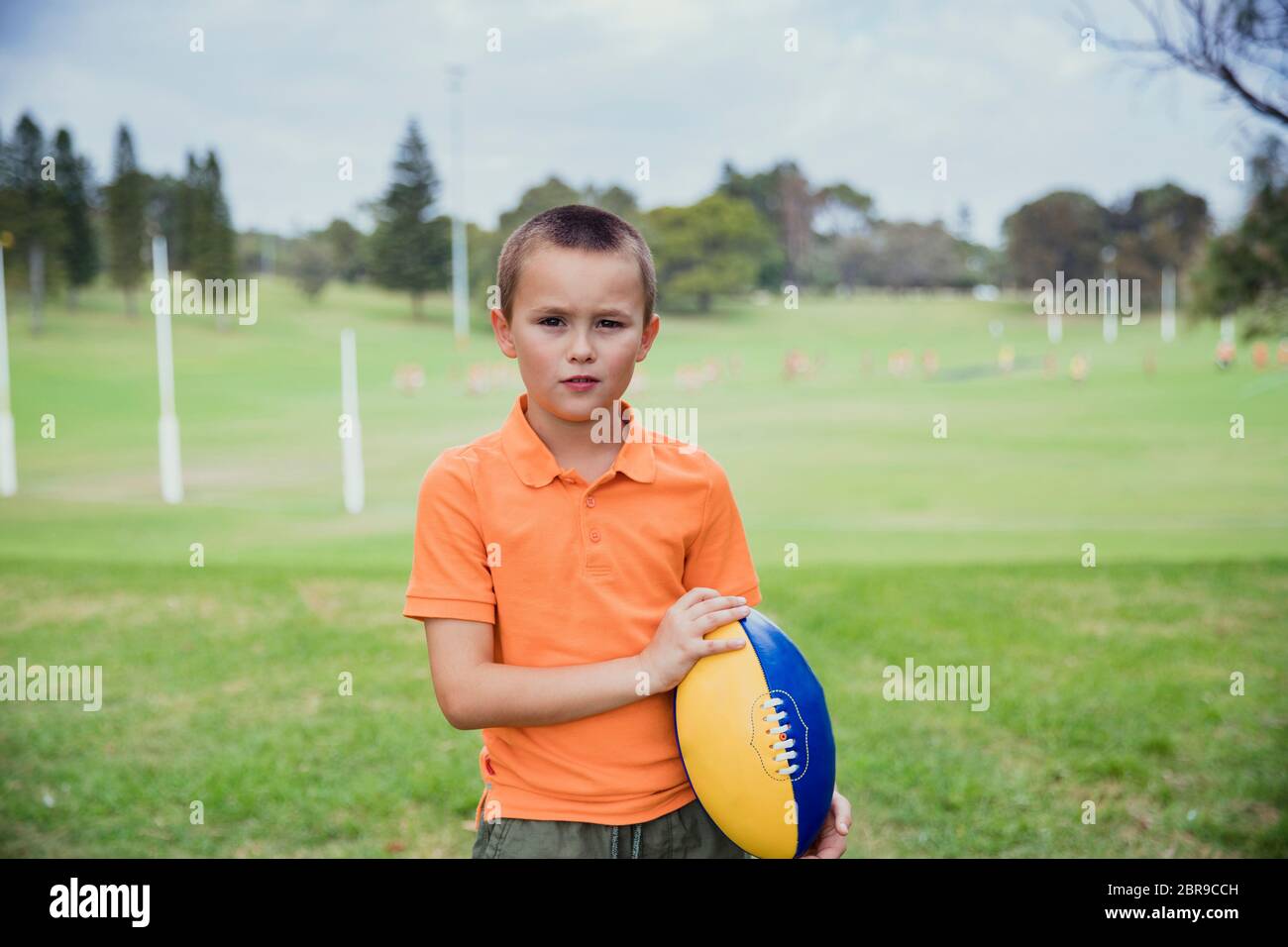 Boy holding rugby ball hires stock photography and images Alamy