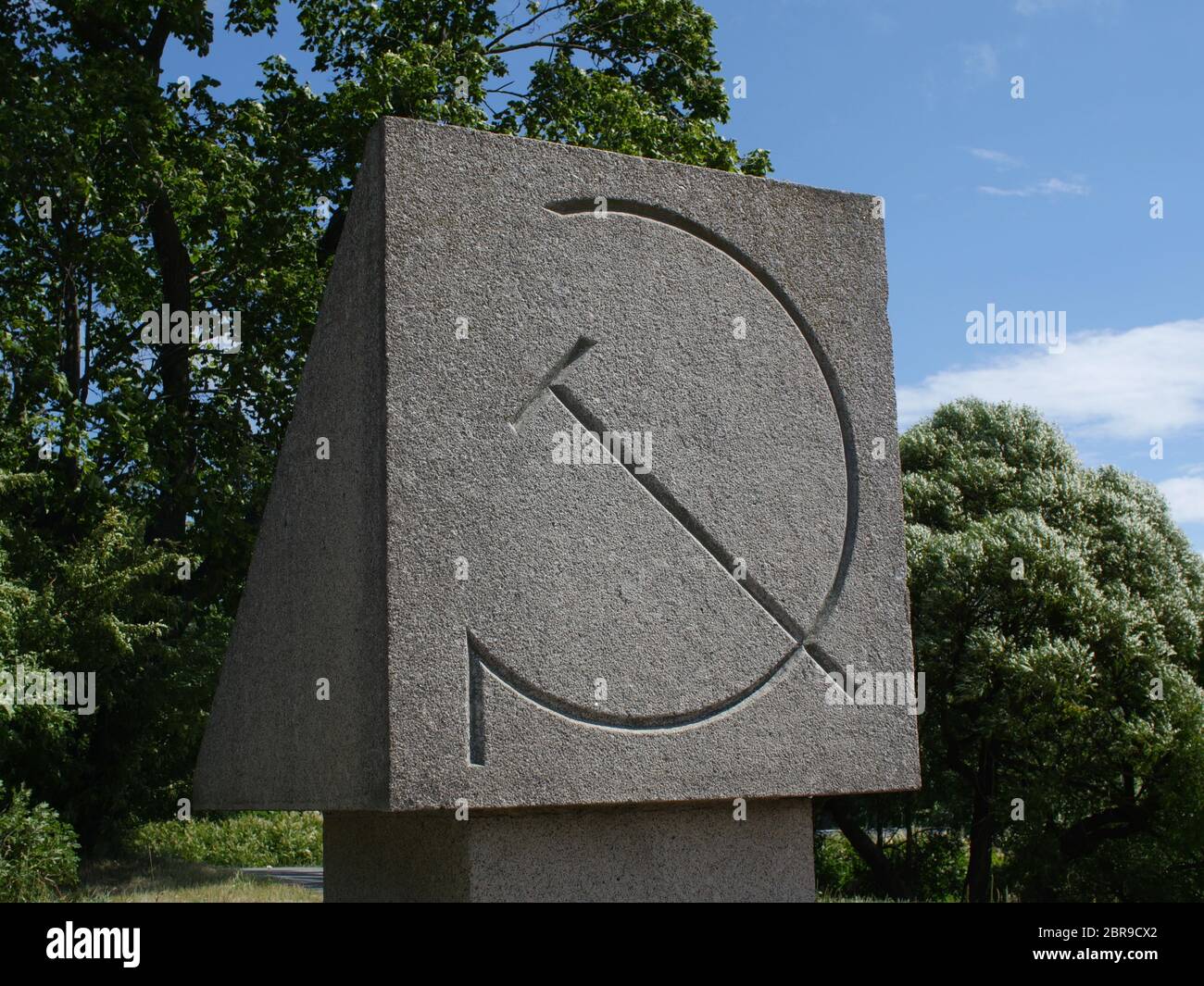 monument with a sickle and hammer,  communist symbol of the Soviet Union Stock Photo