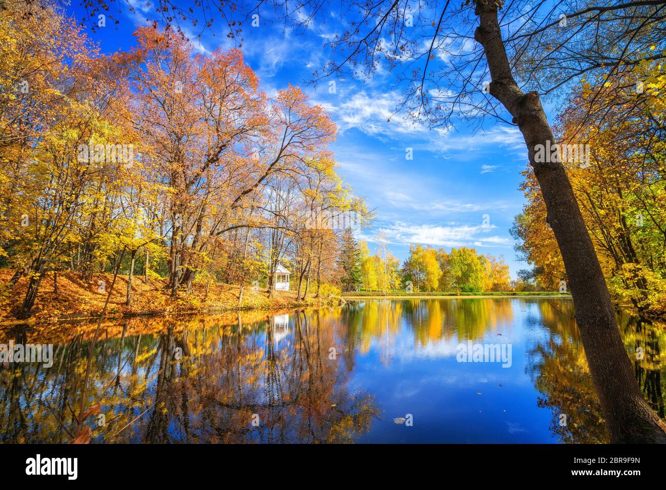 Sunny autumn landscape with blue sky over the lake Stock Photo