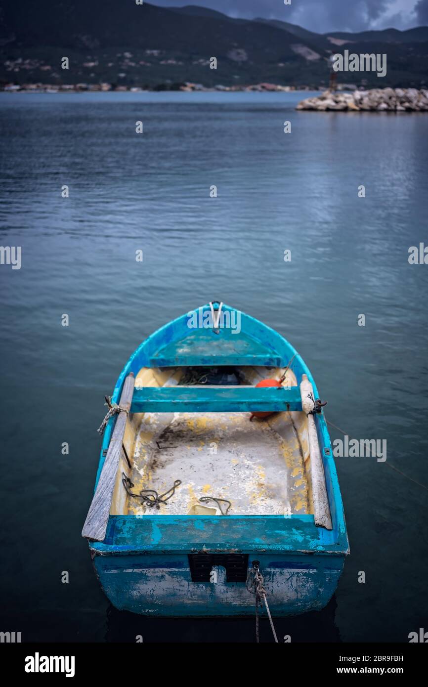 Small blue wooden rowing fisherman boat in the port and harbour in the Alykes Bay in Zante, Greece Stock Photo