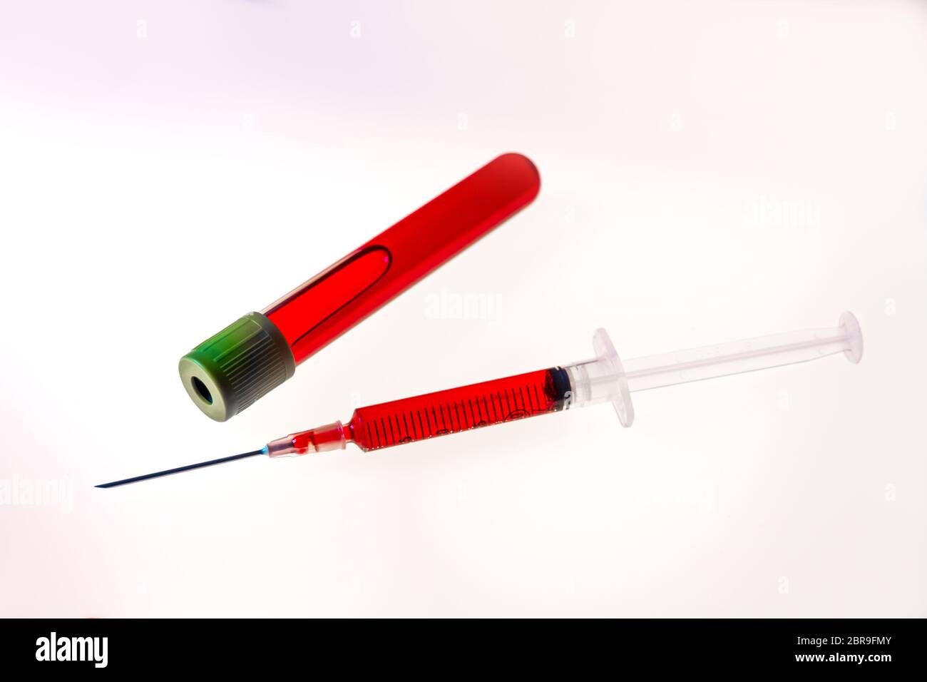 Syringe and test tube with blood isolated on white background Stock ...