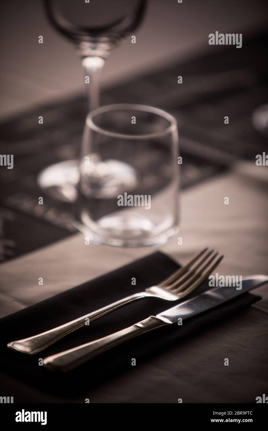 Empty glasses and dish ware on a table in a restaurant Stock Photo - Alamy