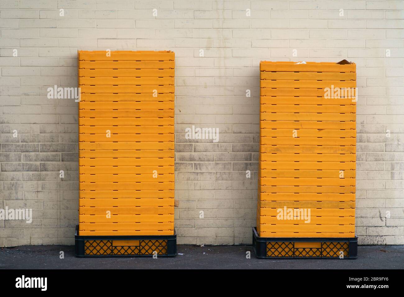 Stacked vegetables boxes and bread boxes in the backyard of a shopping mall. Stock Photo