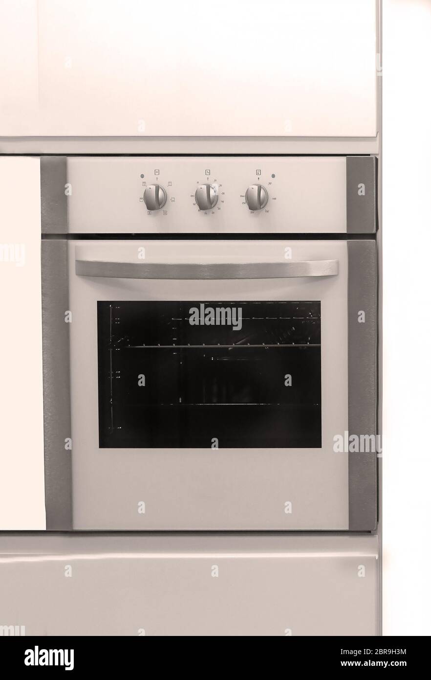 Modern closed kitchen oven built in elements inside interior wall Stock Photo Alamy