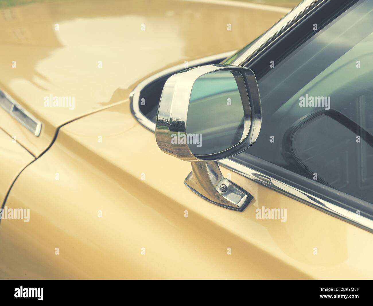 Sideview mirror of an old vintage car, conceptual vintage background