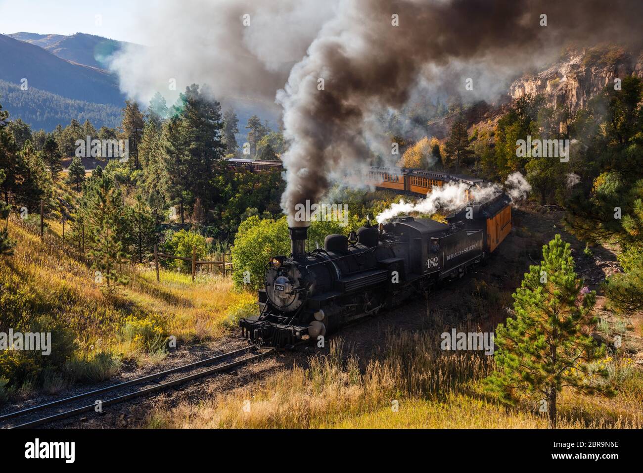 Durango & Silverton Narrow Gauge Railroad coming around a bend with smoke and steam, San Juan Mountains, La Plata County, Colorado Stock Photo