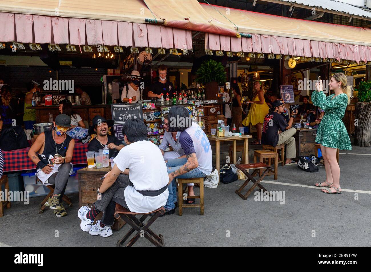 Tourists drink beer at cafe in Chatuchak weekend market Stock Photo