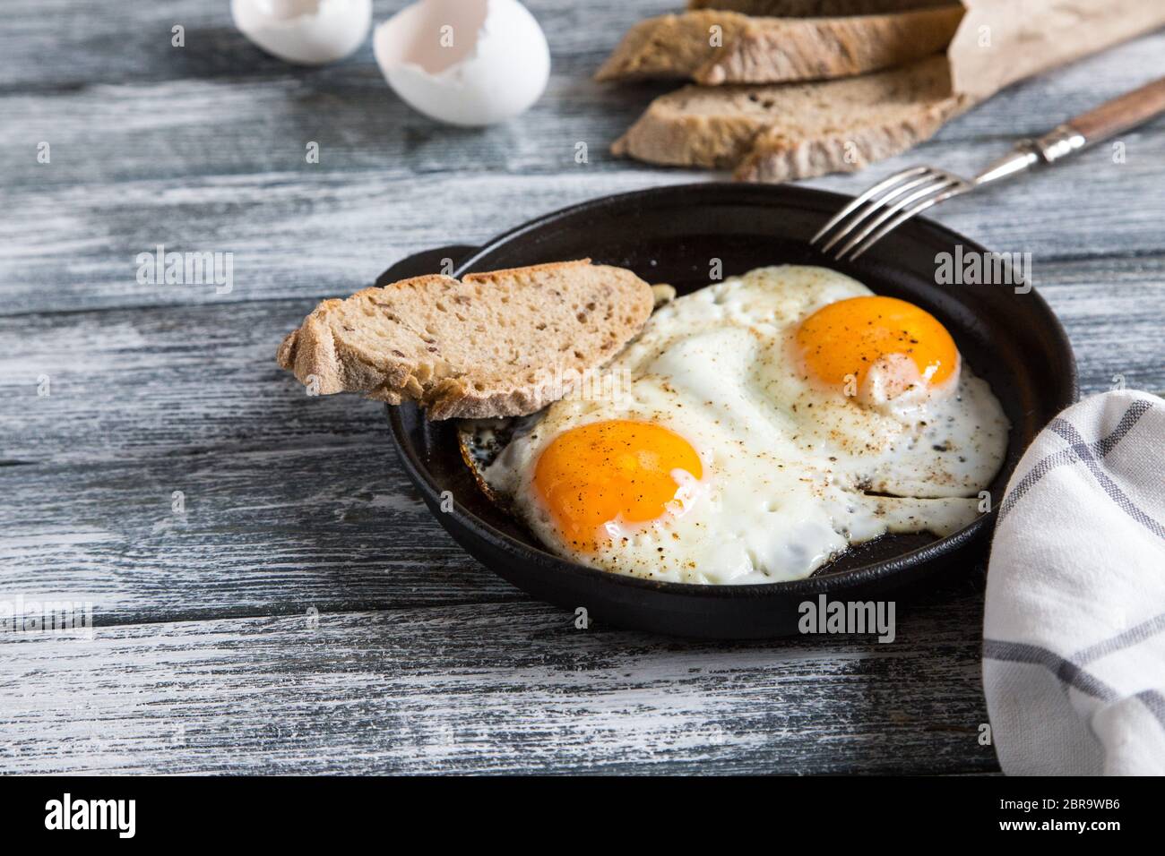 Fried egg. Close up view of the fried egg on a frying pan Stock Photo ...