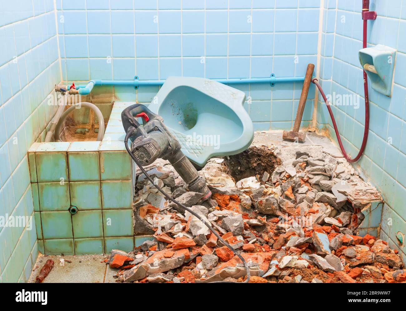 pneumatic hammer repair toilet old bathroom interior house and Large steel hammer Stock Photo