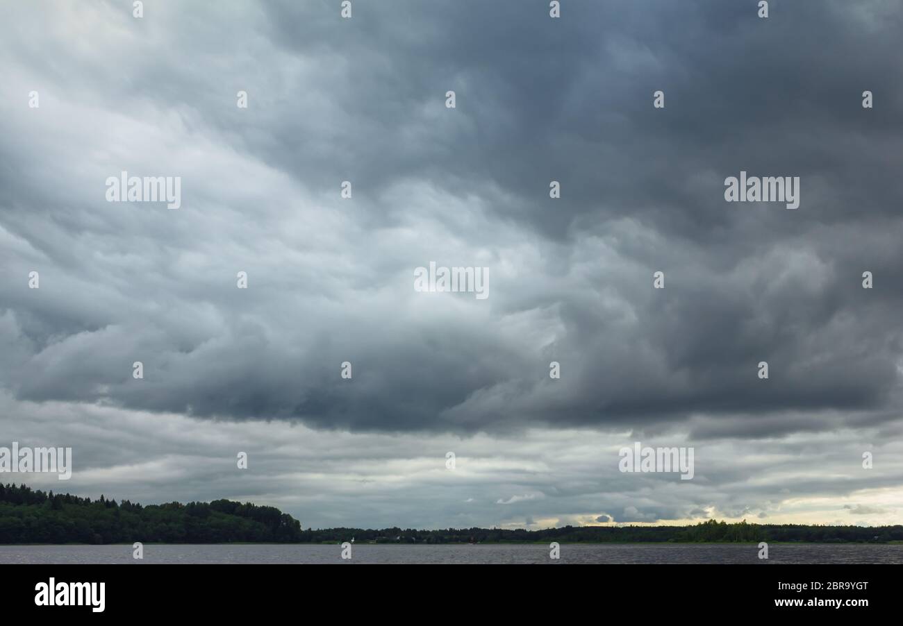 Dramatic dark stormy sky with huge heavy rain clouds before a ...