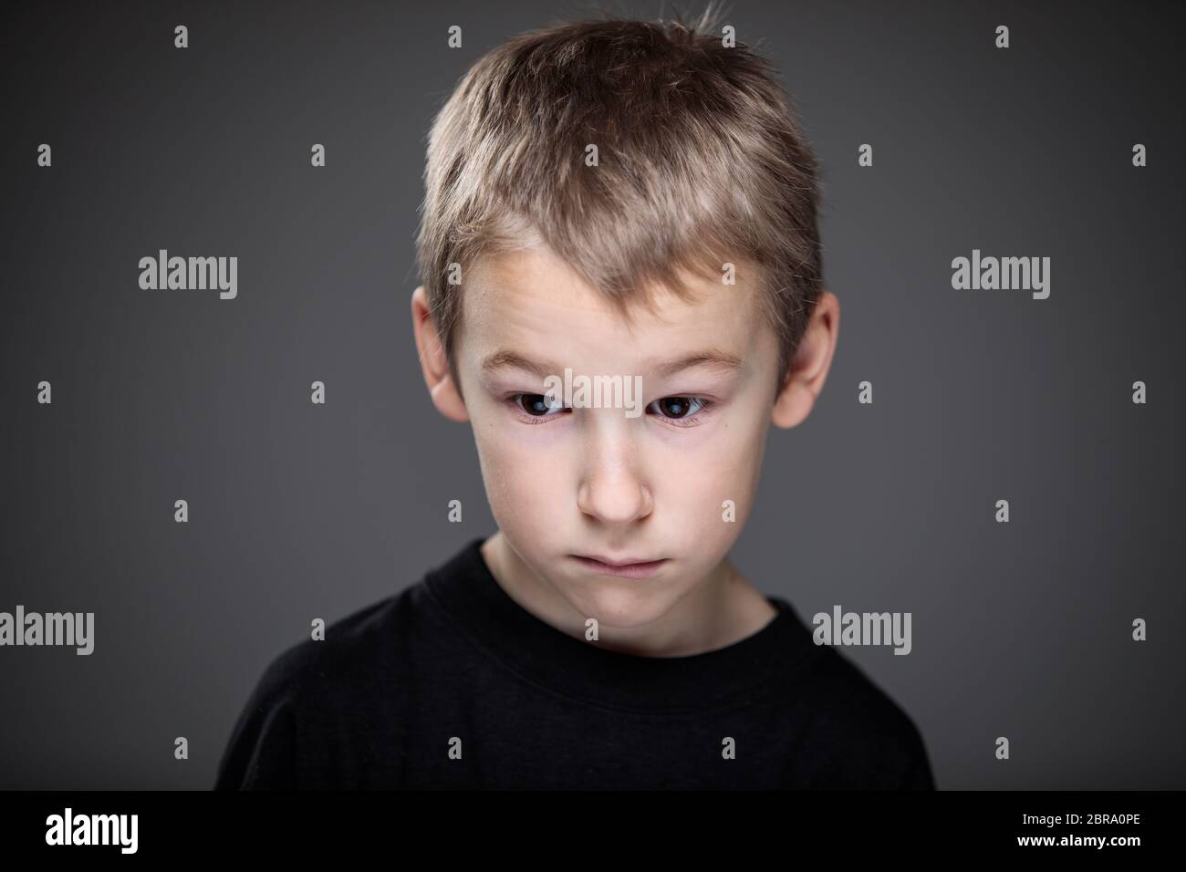 Grief-stricken little boy - feeling intense sorrow, remorse, sadnesss ...